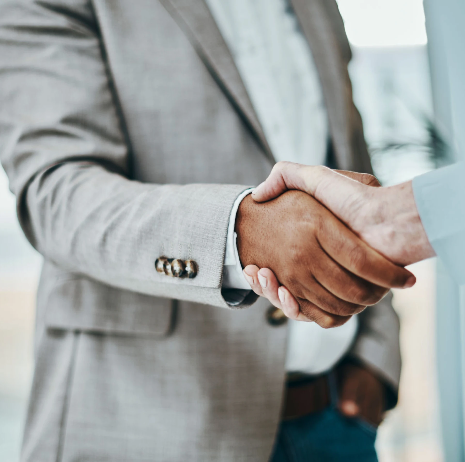 Two people shaking hands in agreement.